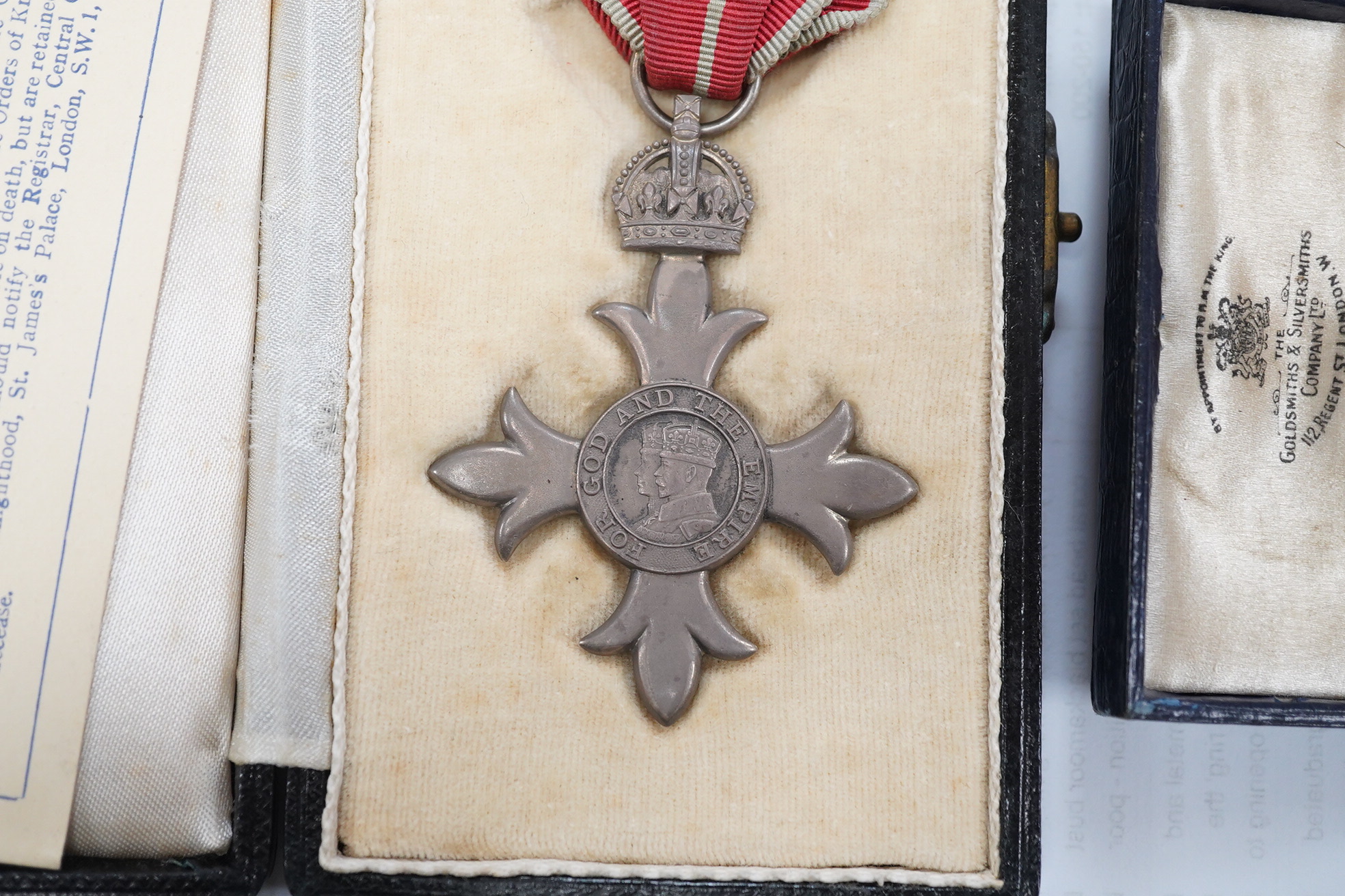 A cased George V military MBE containing leaflet with instructions as to wearing Insignia, together with the separately cased miniature. Condition - fair to good